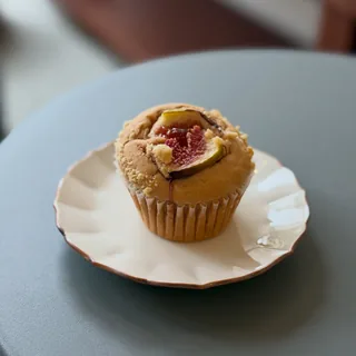 Instagram post (September 23, 2026): a fig-topped muffin on a white scalloped-edge plate