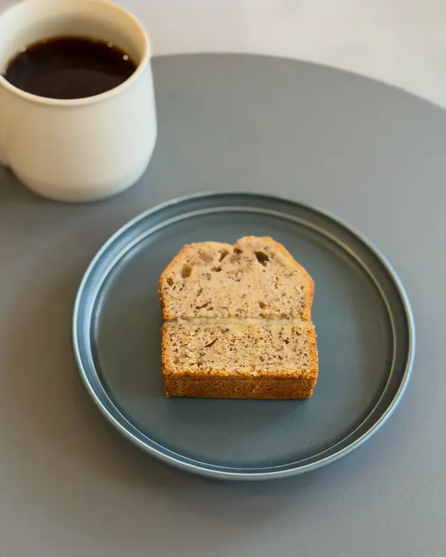 Tea and apple cake on a blue plate, with a cup of coffee